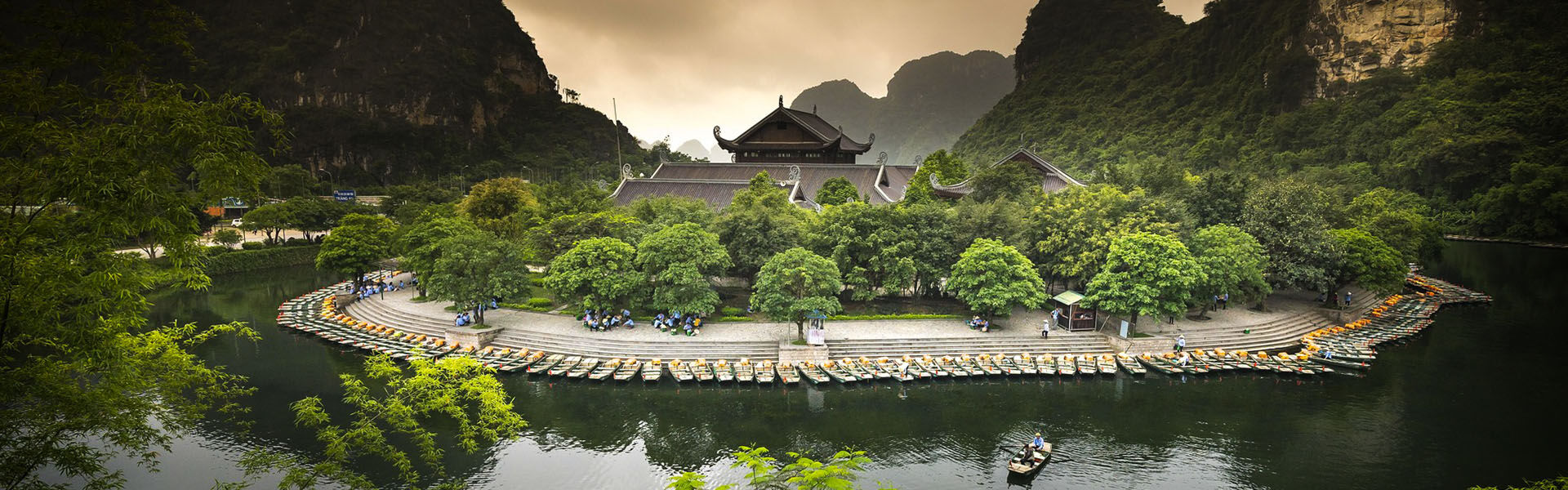 Panoramic view of Ninh Binh’s ancient temples for a scenic Ninh Binh Travel banner by Legend Travel Group.