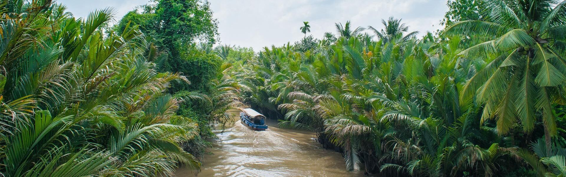 Serene Ben Tre riverside in Vinh Long on a Ben Tre Travel banner by Legend Travel Group.