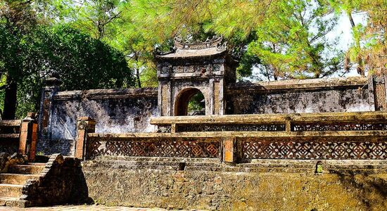 Serene Hue royal tombs landscape on a Hue Tours banner by Legend Travel Group.
