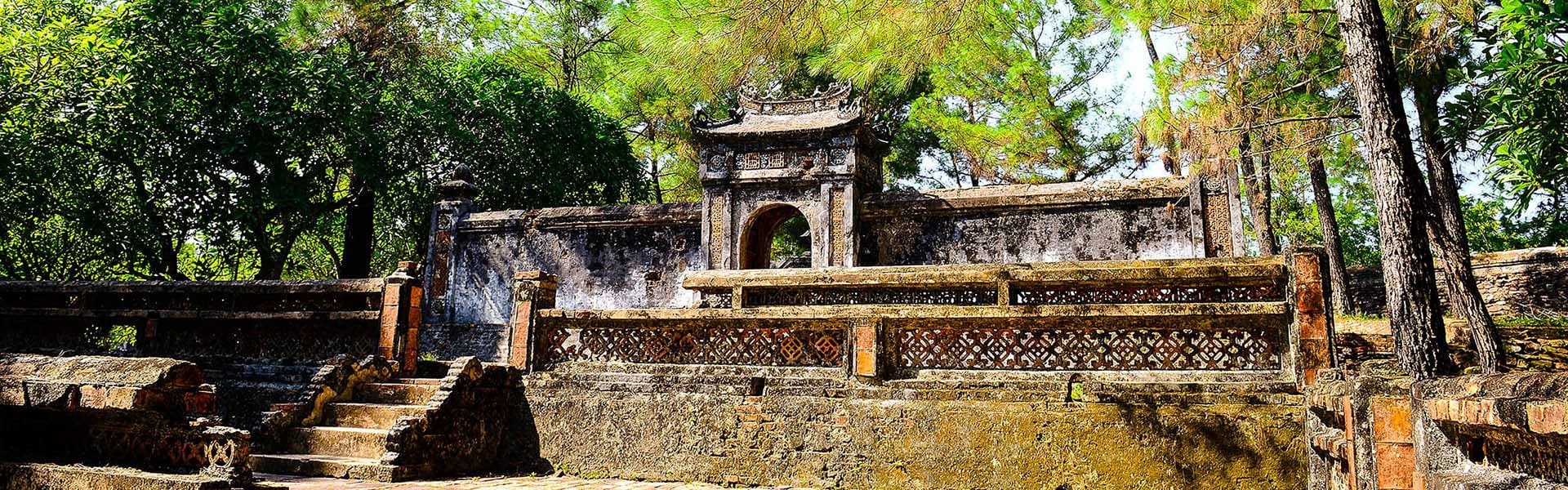 Serene Hue royal tombs landscape on a Hue Tours banner by Legend Travel Group.