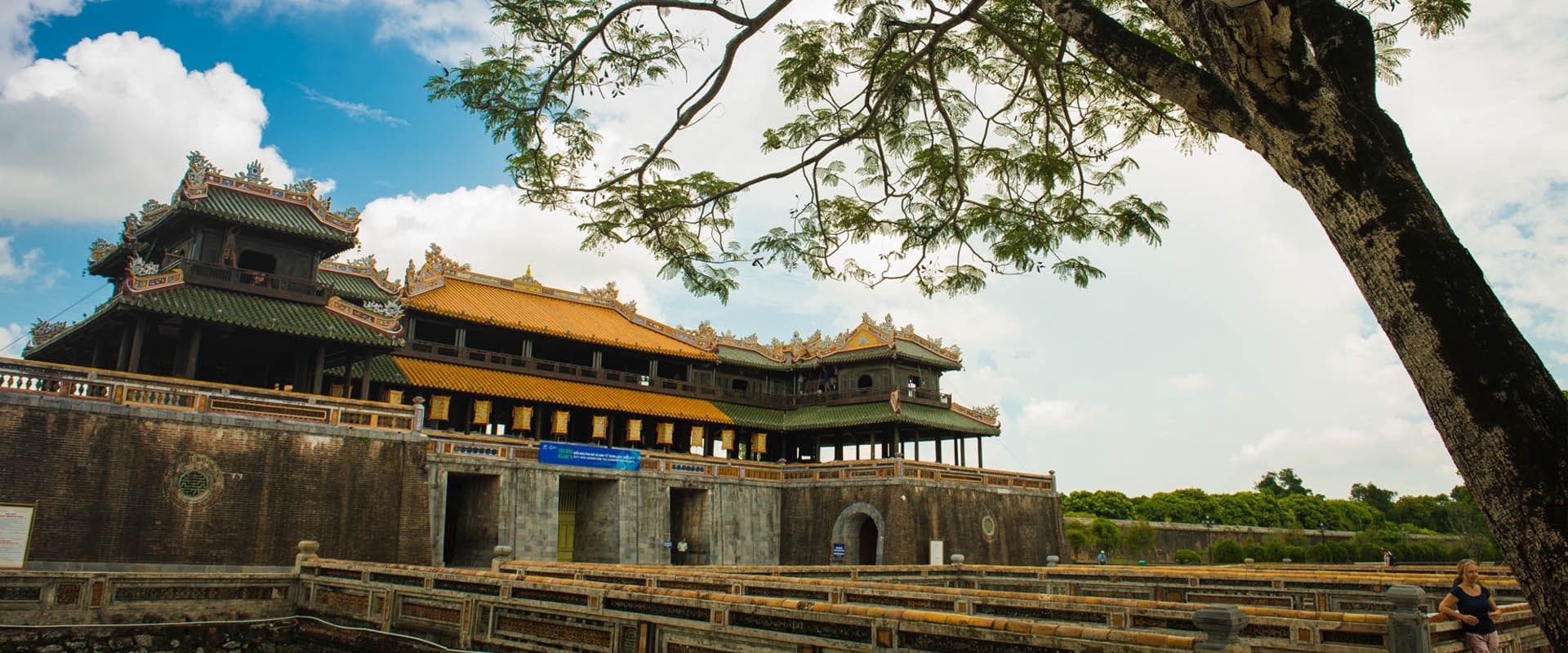 Vibrant Hue palace grounds at dawn for a Hue Travel banner by Legend Travel Group.