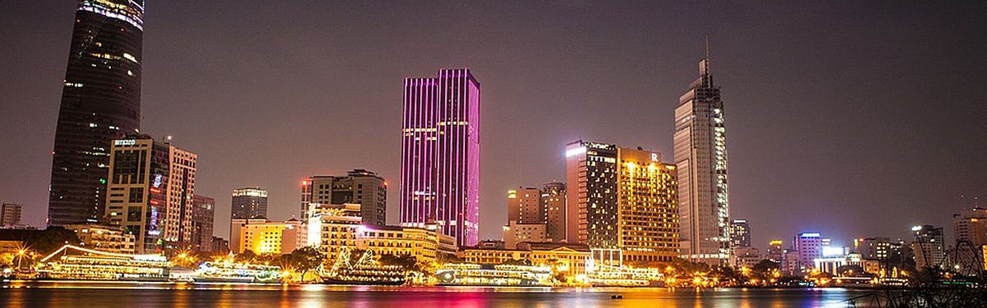 Vibrant Ho Chi Minh City skyline at dusk for a vibrant Ho Chi Minh City Tours banner by Legend Travel Group.