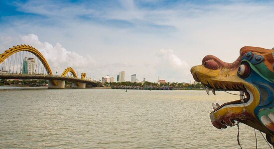 Iconic Da Nang Dragon Bridge for a vibrant Da Nang Tours banner with Legend Travel Group.