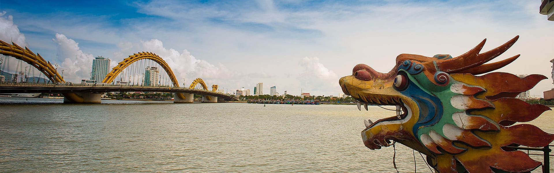 Iconic Da Nang Dragon Bridge for a vibrant Da Nang Tours banner with Legend Travel Group.