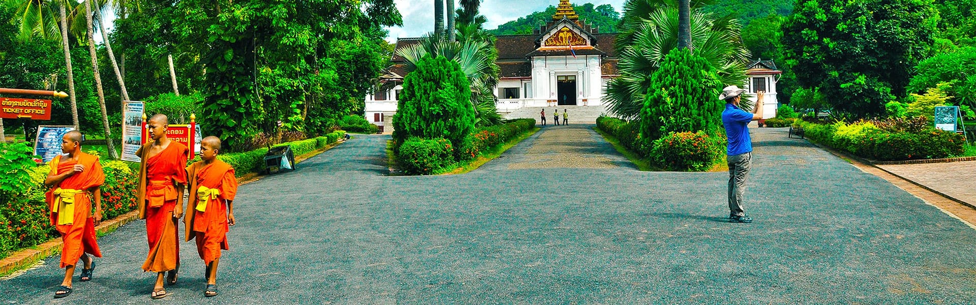 Iconic Laos temple spires for a vibrant Laos Tours banner with Legend Travel Group.