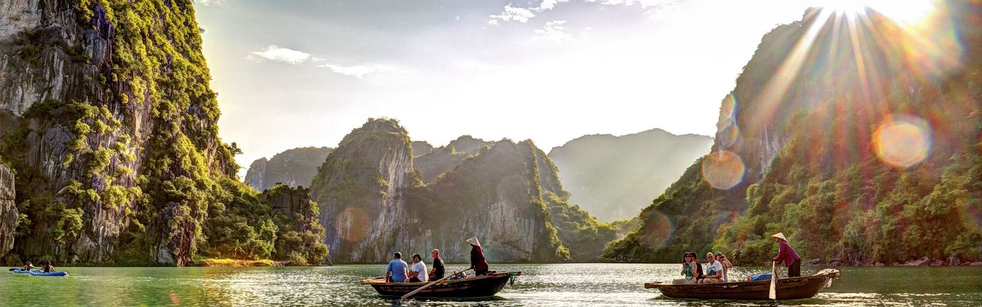 Emerald waters of Halong Bay in Vietnam on a scenic Halong Bay Travel banner by Legend Travel Group.