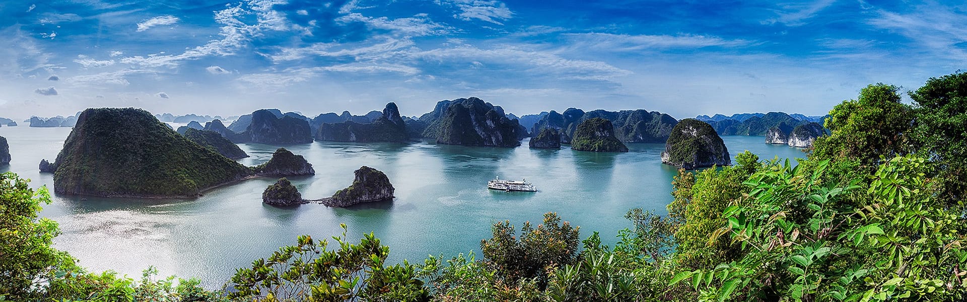 Vibrant Halong Bay seascape at dawn for a Halong Bay Tours banner by Legend Travel Group.