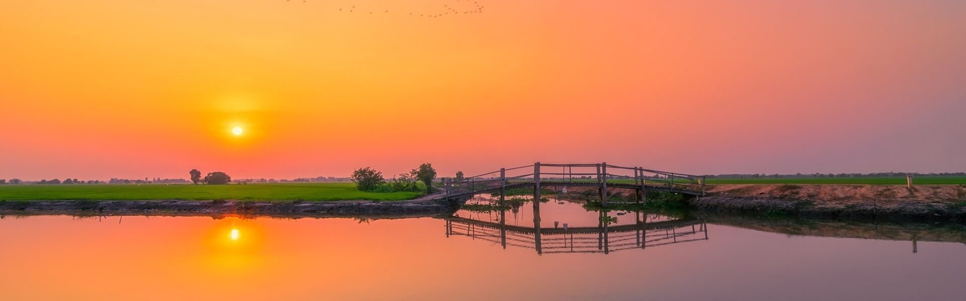 Tranquil Chau Doc delta canals in Vietnam for a Chau Doc Tours banner by Legend Travel Group.