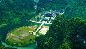Lush greenery and karst mountains during a guided Trang An Tours experience with Legend Travel Group.