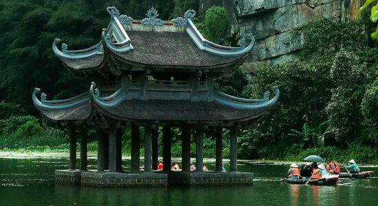 Panoramic view of Ninh Binh’s ancient temples for a scenic Ninh Binh Tours banner by Legend Travel Group.