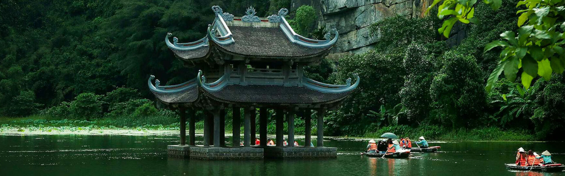 Panoramic view of Ninh Binh’s ancient temples for a scenic Ninh Binh Tours banner by Legend Travel Group.