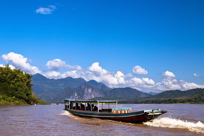 Capture the authentic charm of Laos’ river scene