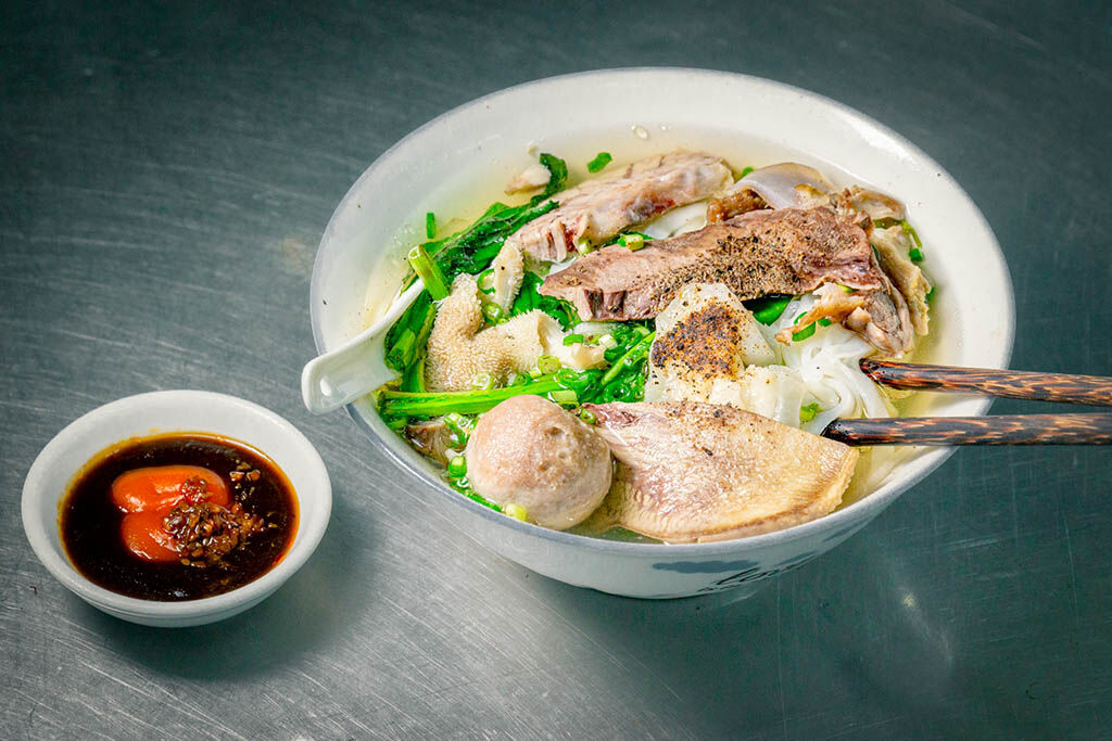 Savor authentic Vietnamese pho from a local stall
