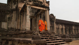 Buddhist Monks walking into the temples in Angkor Complex