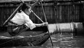 Local girl rowing Boat on Tonle Sap Lake, Cambodia