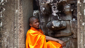 Buddhist Monk sitting at Angkor Thom