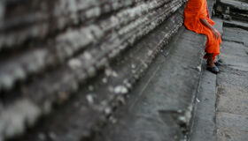 Buddhist Monk sitting at Angkor Temples