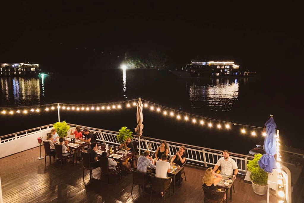 Savor candlelit dinners on deck as night embraces the bay