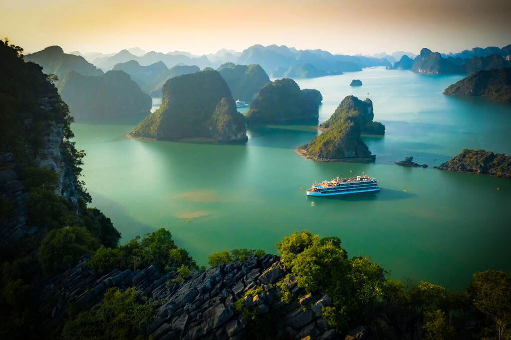 Sail through Vietnam’s iconic limestone karsts at sunrise