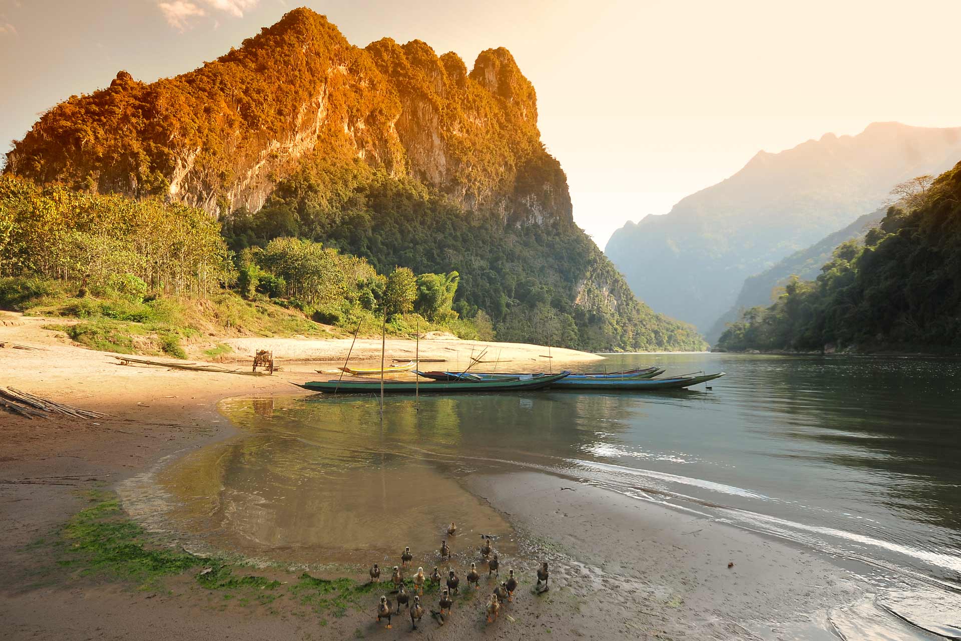 Float through dramatic karst landscapes on the Nam Song River