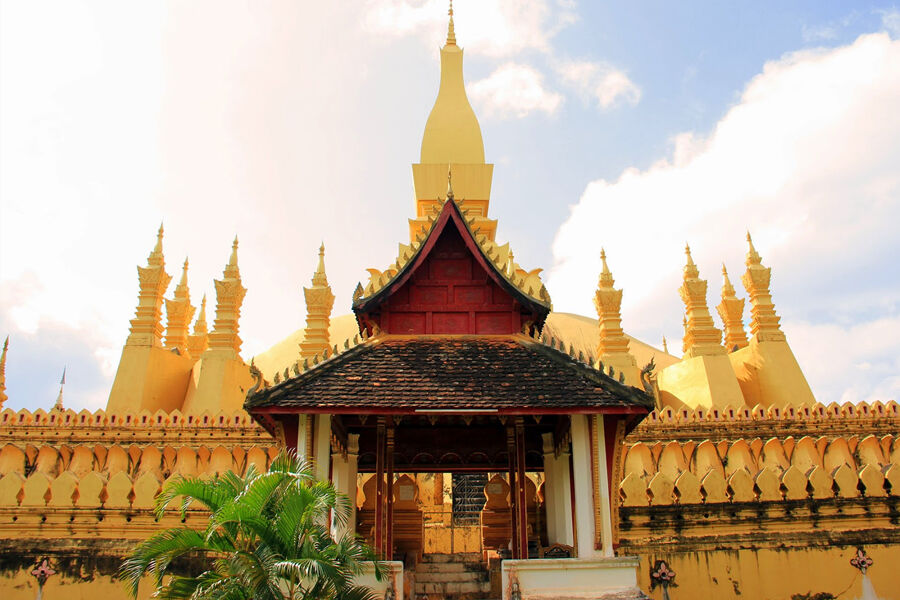 Marvel at Laos’s iconic national symbol glowing at sunset