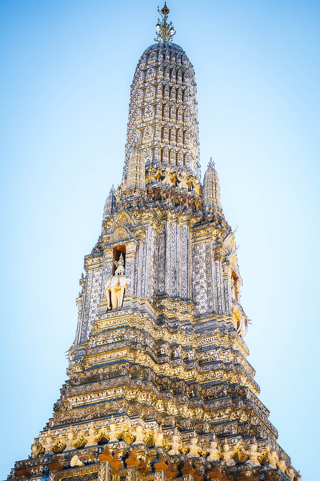 Admire the stunning riverside temple glowing at sunrise