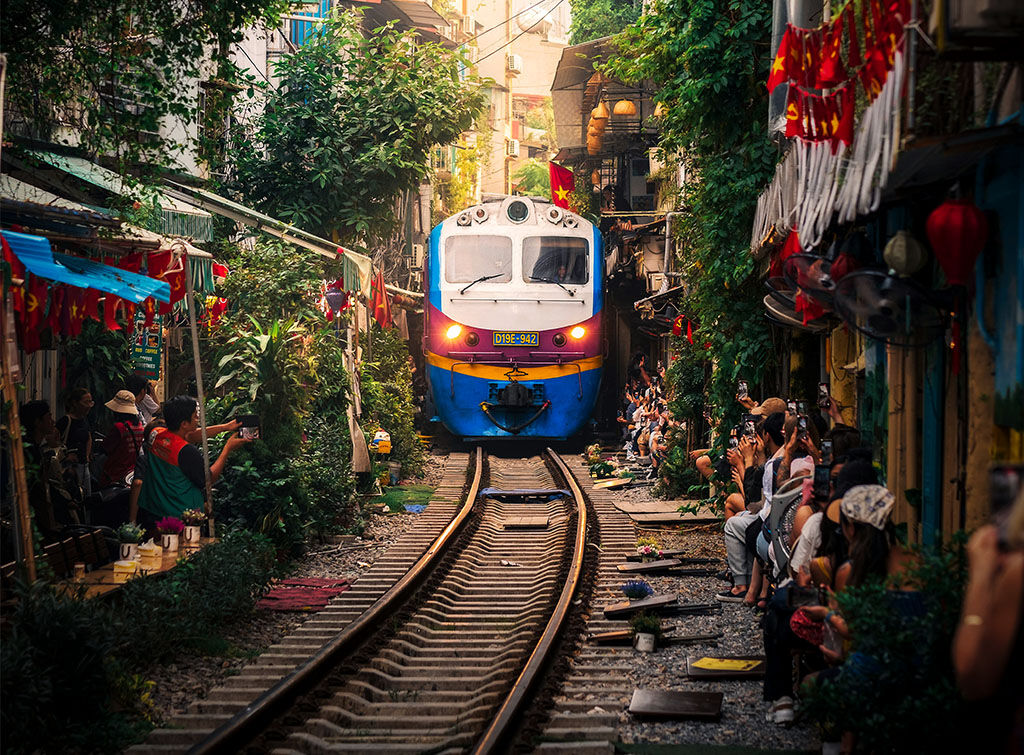 Hanoi’s vibrant Train Streets in Vietnam on a Hanoi Travel banner by Legend Travel Group.