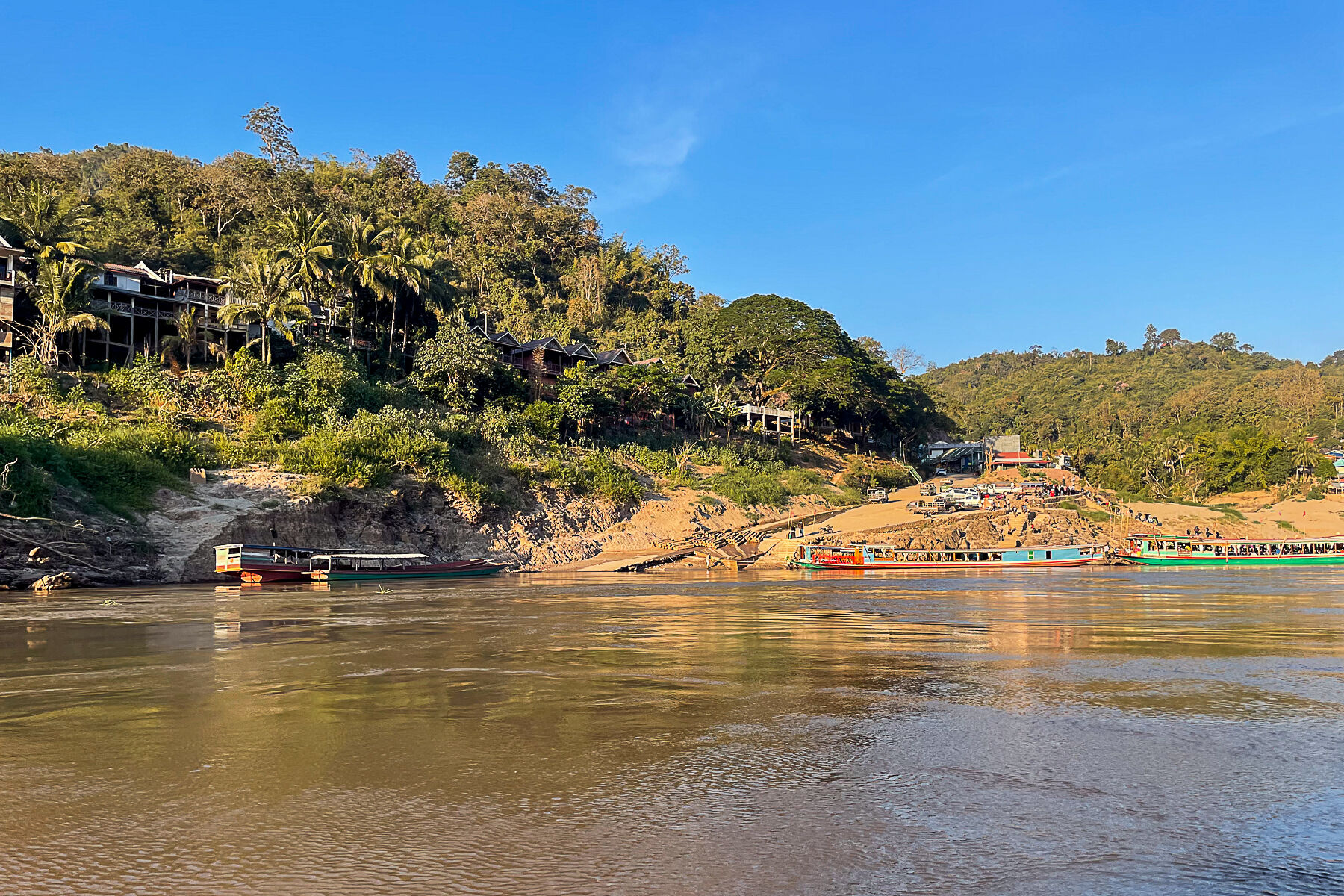 Capture the authentic charm of Laos’ river scene”